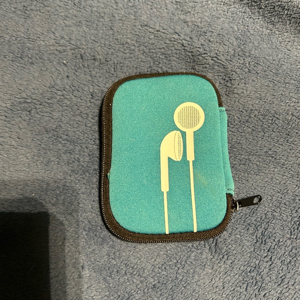 Unbranded earbud carrying case with zipper close and flap to wrap wired bud cord